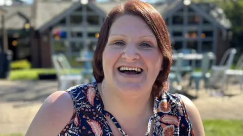 Danielle smiling and showing off her new dentures