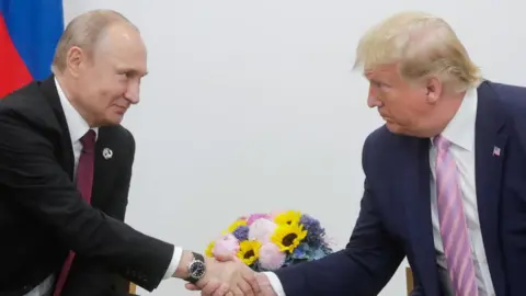 Getty Images Vladimir Putin and Donald Trump shaking hands at the G20 summit in Osaka in 2019