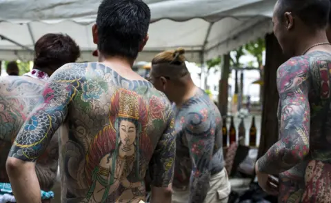 Anadolu Agency/Getty Images Yakuza members display their tattoos at the Sanja Matsuri Festival in Tokyo's Asakusa district, on May 14, 2016.