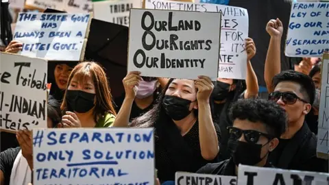 Getty Images Tribal people of Manipur take part in a 'Tribal Solidarity protest' against the ongoing tension in the state, at Jantar Mantar on May 31, 2023 in New Delhi, India.