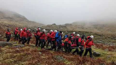 Wasdale Mountain Rescue Team The injured walker is stretchered off the mountain by rescuers