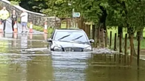 South Wales Police / @SWP_Roads Car stuck at Dipping Bridge near Merthyr Mawr