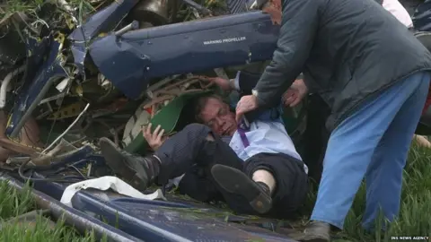 Ins News Agency Nigel Farage is helped from the wreckage of his plane after it crashed on polling day in the 2010 election