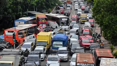 Getty Images Motorists are seen during a traffic jam in Jakarta on March 6, 2019.