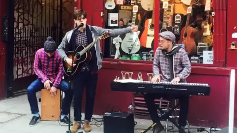 Hank's Guitar Shop / Facebook Yungblud performs outside Hank's Guitar Shop