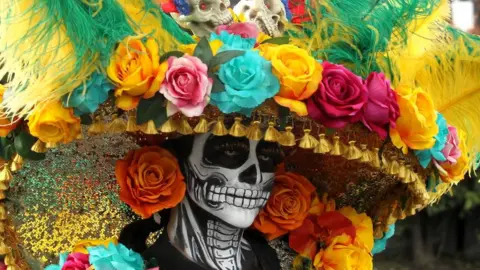 AFP A woman with skeleton make-up has a large floral hat on