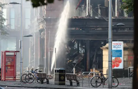 PA The charred Bank Buildings in Belfast city centre