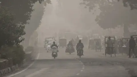 Getty Images Traffic on a street in Delhi amid heavy smog in November 2016