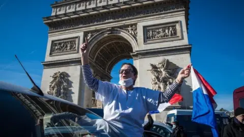 EPA A protester by the Arc de Triomphe