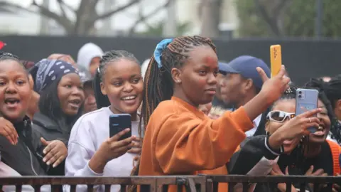 Ziyaad Douglas/Getty Images Concert goers holding up phones on Thursday.