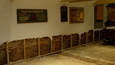 Jamie Niblock/BBC Inside the pub after flood damage