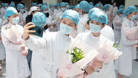 Barcroft Media/Getty Images Female medical workers are literally nicknamed in Chinese "beauties who go against the tide"