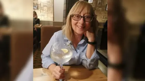 Family Handout A women smiling in a pub