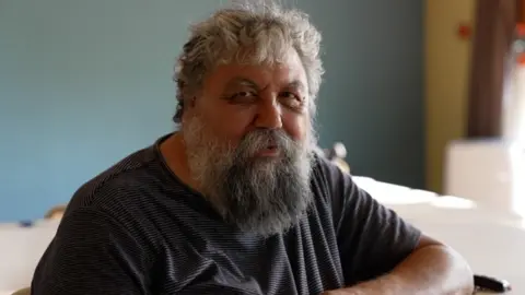 BBC Christian Fostitschenko smiles for the camera behind his long grey beard