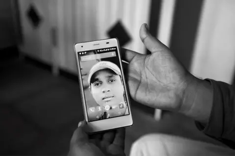 Sudharak Olwe A family member holding Sagar Shejwal’s photo.