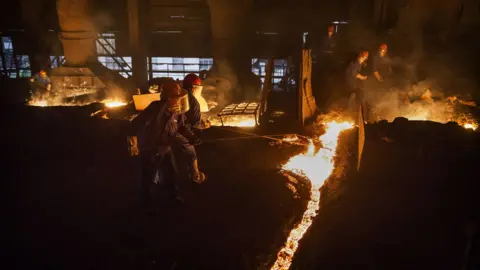 Getty Images Chinese steelworkers at a smelter