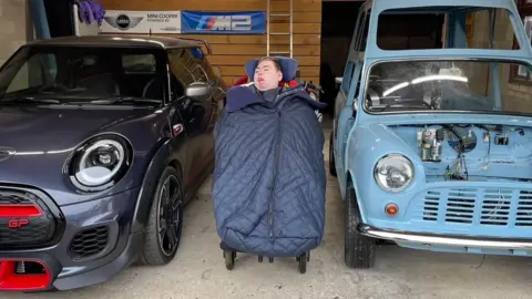 Robin Middleton Charlie beside his 'Pope mobile' and another mini car