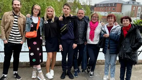 Claire Bickford Two sponsor couples pictured with their Ukrainian family - Hannah and David pictured beside Nataliya and Taras, next to Alan and Claire, and Iryna and Helen