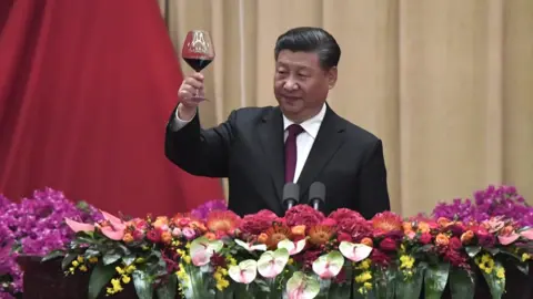 Getty Images Xi Jinping raises a toast during banquet marking 70 years of Communist Party rule