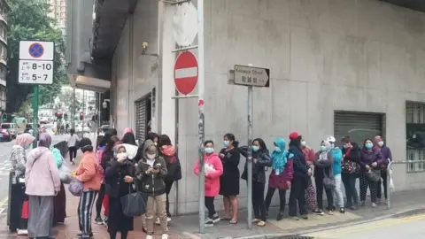 KJRI Hong Kong Indonesian citizens queue for free masks at the Indonesian Consulate General in Hong Kong.