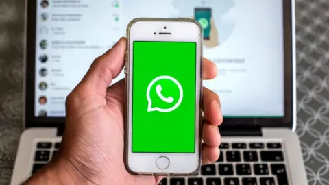 Getty Images WhatsApp on phone held against keyboard