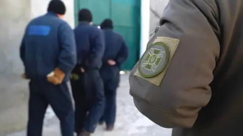 BBC Russian prisoners of war at a facility in western Ukraine