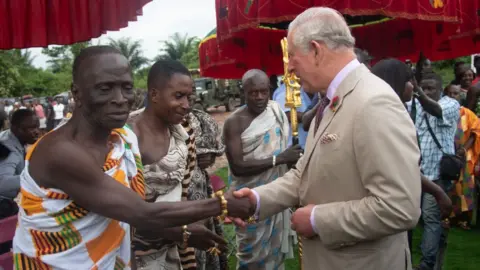 Getty Images Prince Charles, Prince of Wales tours a Cocoa Farm on November 4, 2018 in Kumasi, Ghana. The Prince was greeted by the Livelihoods and Climate Adviser for D.F.I.D. Ghana, Mr. Nicholas Baynham, the Chief of Kona, Nana Konadu Yiadom Kumanin IV and was accompanied by the farm owner, Mr. Agyin Brefo