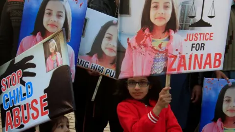 Reuters A girl holds a sign as she chants slogans with others to condemn the rape and killing of Zainab Ansari in Kasur, during a protest in Lahore, Pakistan on 14 January 2018