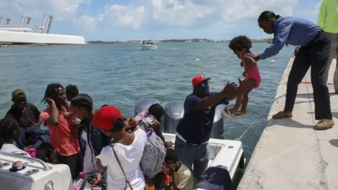 Getty Images Thousands of people are attempting to flee Great Abaco and Grand Bahama, two of the worst-hit areas