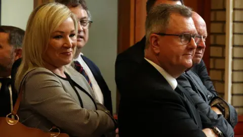 Pool Michelle O'Neill and Jeffrey Donaldson at the funeral of David Trimble in 2022