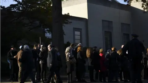 AFP A long line has formed outside the Rodef Shalom Congregation ahead of the first funeral service for the victims