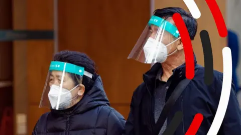 Two people wearing PPE