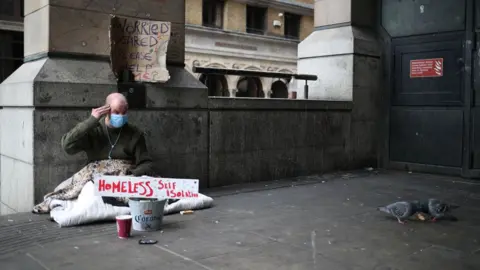 Reuters A homeless man wearing a protective face mask is seen in Westminster, as the spread of the coronavirus disease (COVID-19) continues, London, Britain