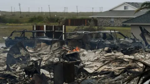 AFP A burnt out house and cars that caught fire are seen after Hurricane Harvey hit Corpus Christi, Texas on August 26, 2017