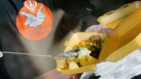 Birmingham New Street Station Volunteer serving food