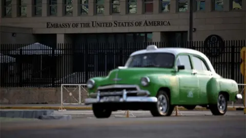 Reuters A green car driving past the US embassy in Havana