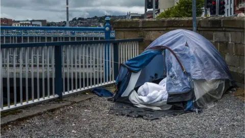 Getty Images Homeless person's tent by a river