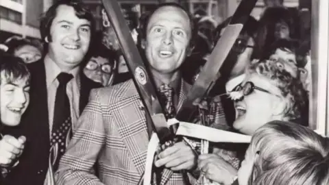 Taylors Eye Witness Geoff Boycott with the giant scissors