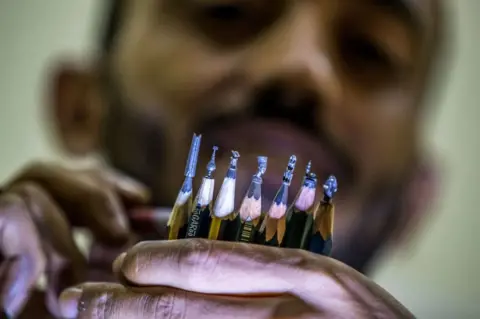 AFP Ibrahim Bilal, an Egyptian artist, presents finished sculptures of Ancient Egyptian figurines, a book, a mosque, and other shapes.