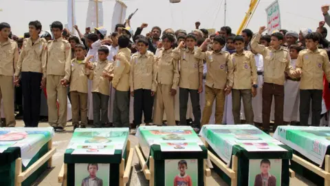 Getty Images Children at the funerals of dozens of children killed in an air strike on the rebel stronghold of Saada, 13 August 2018