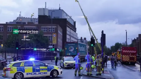 Jonathan Brady Firefighters at the scene at the business centre in Fairfield Road, Bow