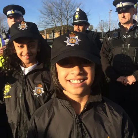 Aliyah (front) and Zeena (left) with three Gwent Police officers