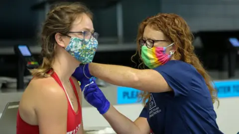 Getty Images Woman receiving Covid jab in London