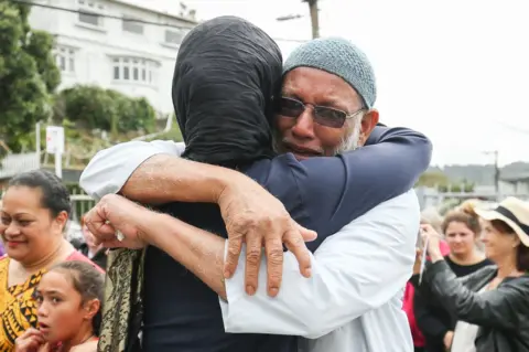 Getty Images Jacinda Ardern hugs man