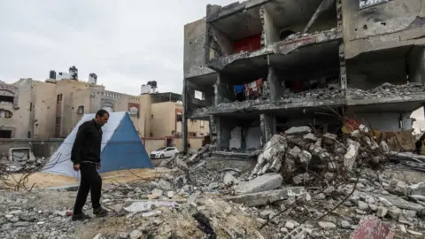 Getty Images Palestinian lives in a tent on the ruins of his house