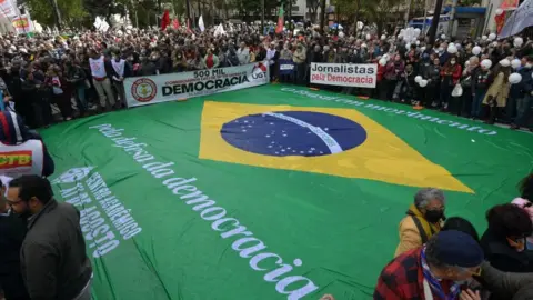 Getty Images A Brazilian flag is spread on the ground during a democracy demonstration in Sao Paulo