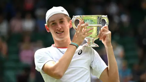 Getty Images Henry Searle with the Wimbledon Boys trophy