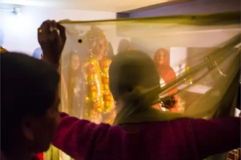 AFP Celebration of a traditional indian marriage with bride, indian woman wearing festive clothes and groom, mother in law and father in law, friends and family on December 01, 2012 in Dharamsala, Himachal Pradesh, India