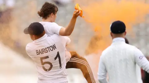 Getty Images Jonny Bairstow carries off protester