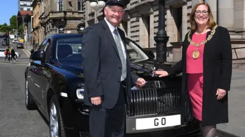 Former Lord Provost and driver standing beside Rolls Royce